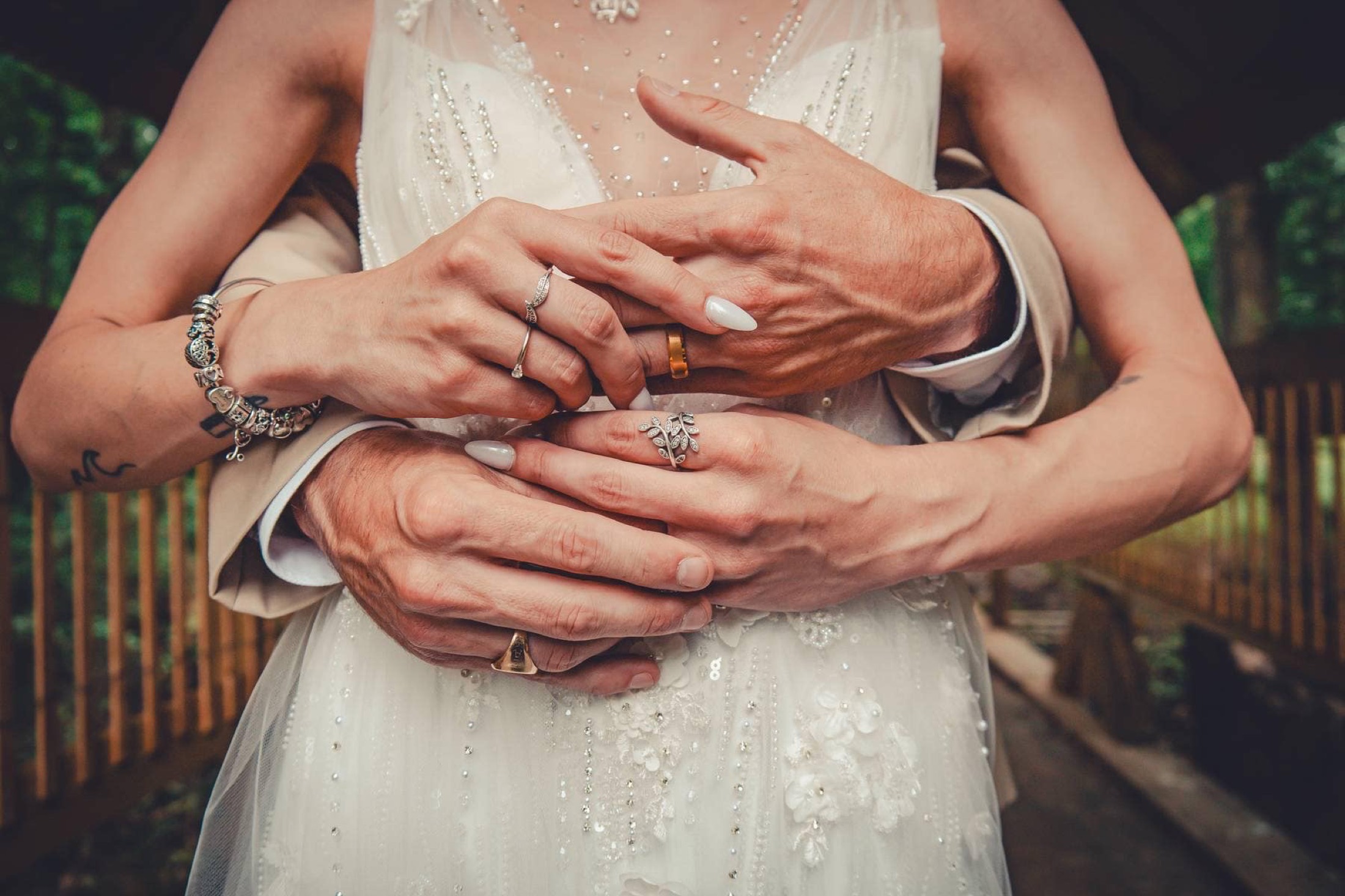 The couple's hands, clasped